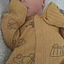 newborn, baby, sleeping, onesie, yellow_clothing, infant, cozy, blanket, cute, peaceful, face, hand, soft, indoor, child, portrait, resting, comfort, toddler, clothing