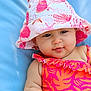 baby, child, face, hat, bucket_hat, swimsuit, pink, orange, seashell_pattern, skin, blue_background, infant, cute, summer, outdoor, portrait, smile, baby_fashion, chubby_cheeks, relaxing