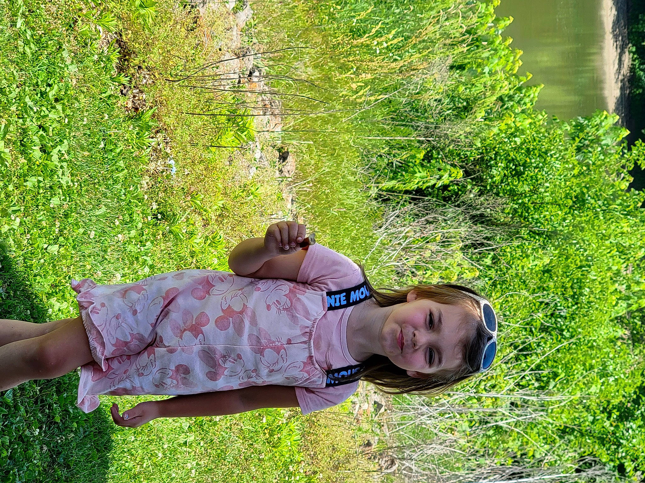 Delilah is registered to the contest to win money with this photo: child, fun, grass, grass_family, grassland, groundcover, happy, human_leg, landscape, lawn, leaf, leisure, people_in_nature, person, plant, shrub, sitting, spring, sunlight, toddler