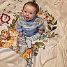 Nova joined the competition — help win amazing prizes! baby, child, smiling, striped_clothing, sitting, blanket, animal_print, indoor, happy, cute, young_child, playful, portrait, face, feet, cozy, toddler, colorful, expression, person