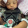 baby, blanket, car_seat, child, child_seat, closeup, cozy, cute, headband, infant, mittens, newborn, peaceful, pink_bow, portrait, relaxed, resting, safety_harness, sleeping, soft_lighting