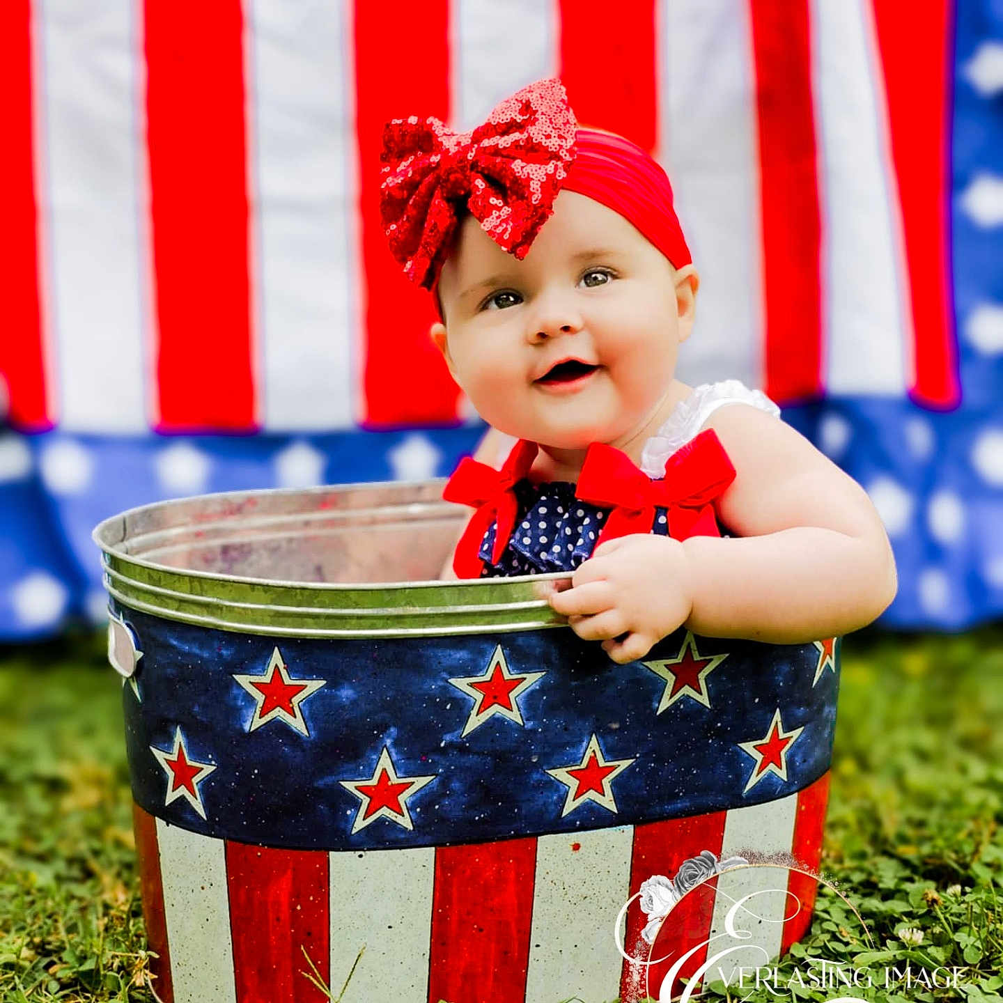 Le'Norah joined the competition — help win amazing prizes! american_flag, baby, blue, bucket, child, cute, grass, headband, holiday, infant, outdoor, patriotic, portrait, red, red_bow, smiling, stars, stripes, summer, white