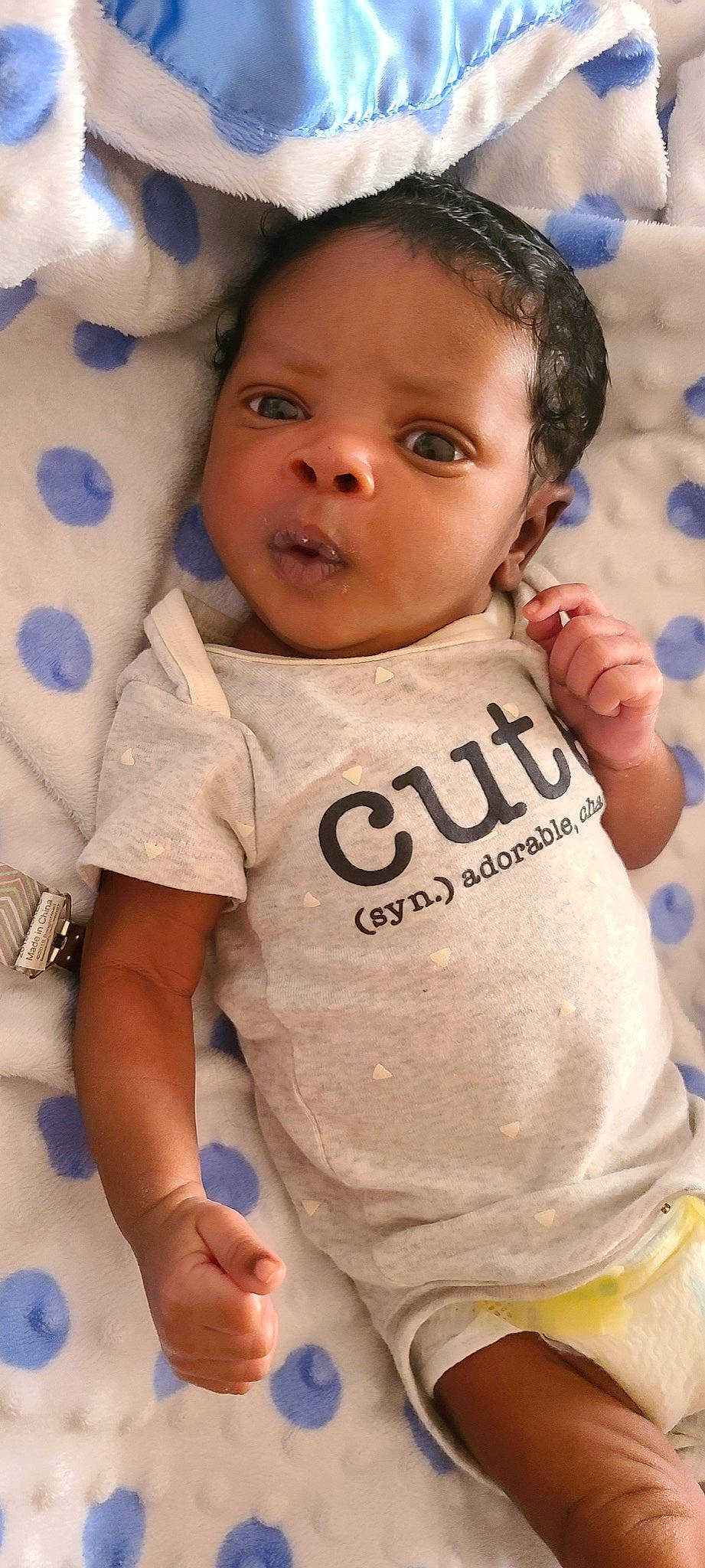 Kristian is registered to the contest to win money with this photo: arm, baby, baby_toddler_clothing, blue, cheek, eye, eyelash, face, finger, gesture, happy, head, neck, nose, person, skin, sleeve, t_shirt, textile, toddler