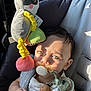 baby, pacifier, car_seat, toy, stuffed_animal, child, infant, sunlight, shadow, seatbelt, cute, toddler, closeup, face, hand, clothing, indoor, comfort, relaxation, childcare