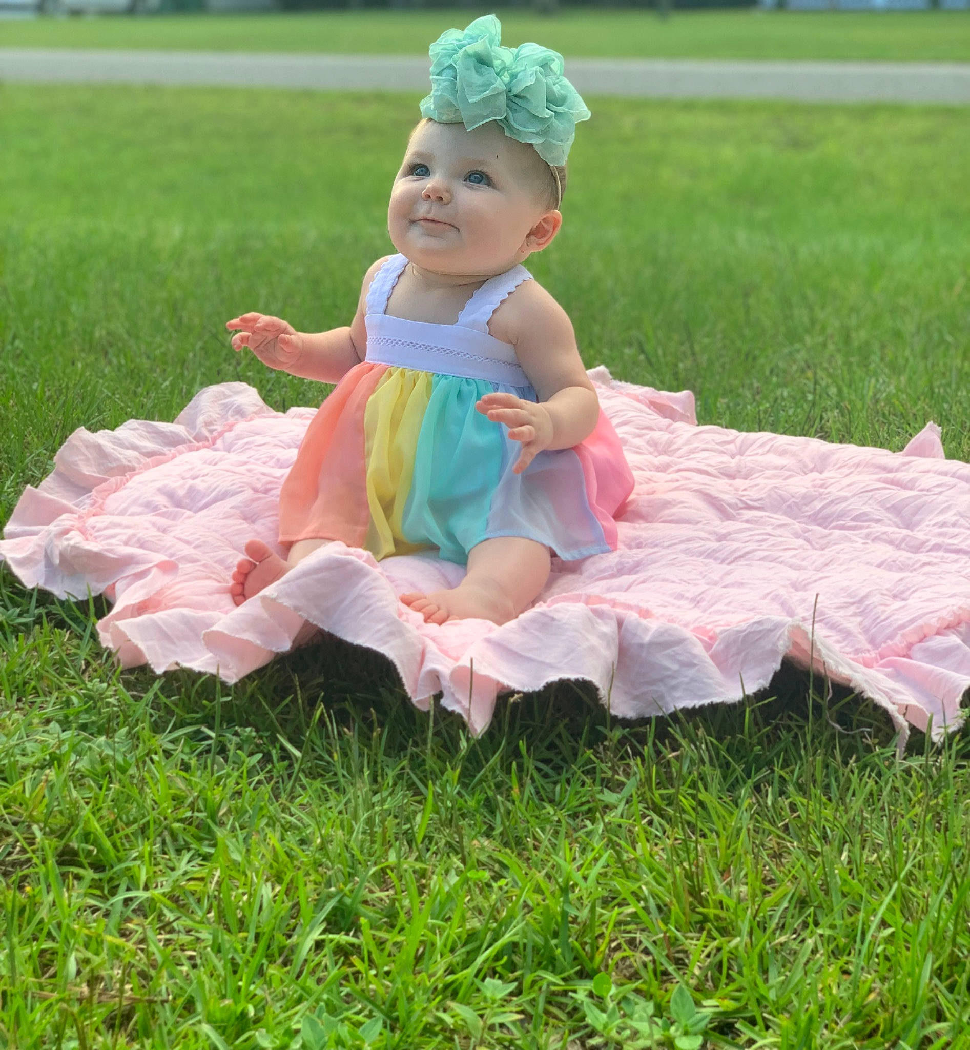 Raelynn is registered to the contest to win money with this photo: baby, baby_toddler_clothing, child, dress, face, fun, grass, grass_family, green, happy, head, headpiece, headwear, meadow, people_in_nature, person, pink, plant, smile, textile