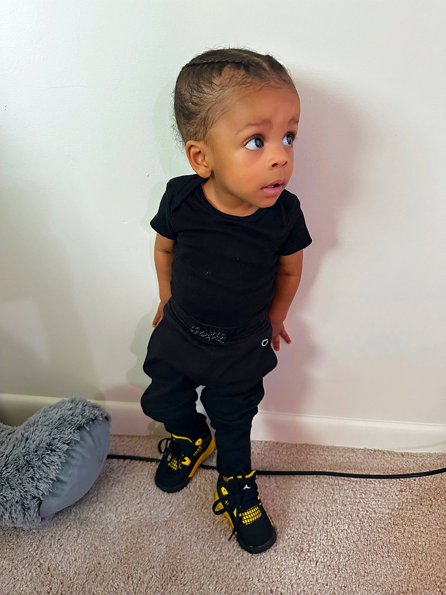 Kyron is registered to the contest to win money with this photo: arm, baby_toddler_clothing, calf, child, electric_blue, fashion_design, flooring, human_body, human_leg, knee, one_piece_garment, pattern, person, shoulder, sitting, sleeve, surprise, toddler
