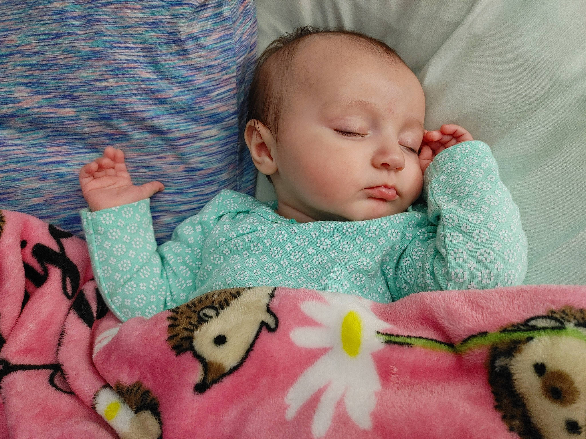 Sydney is registered to the contest to win money with this photo: baby, baby_products, baby_sleeping, baby_toddler_clothing, cheek, child, comfort, linens, mammal, nose, orange, person, pink, product, room, skin, sleeve, textile, toddler, toy
