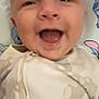 Harrison is registered to the contest to win money with this photo: baby, smiling, face, mouth_open, onesie, blanket, infant, happy, child, cute, skin, head, person, lying_down, closeup, indoors, joy, expression, young, sleepwear