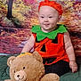 autumn, baby, background, blanket, child, cute, festive, green, halloween, hat, holiday, indoor, orange, person, plush_toy, portrait, pumpkin_costume, sitting, smiling, teddy_bear