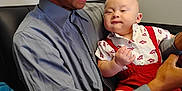 Jacob Ap is registered to the contest to win money with this photo: arm, baby, cap, casual, child, couch, family, happy, holding, indoor, interaction, man, person, portrait, red_clothing, seated, shirt, skin, smile, toddler