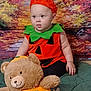 autumn, baby, blanket, child, costume, cute, fall_colors, festive, green, halloween, holiday, indoor, orange, plush_toy, portrait, pumpkin_costume, sitting, smiling_toy, teddy_bear, young_child