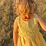 toddler, child, blonde_hair, curly_hair, yellow_dress, lace, outdoor, field, grass, sunlight, portrait, cute, young_child, smiling, nature, summer, innocent, happy, daylight, soft_focus
