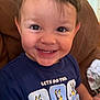 Malakai joined the competition — help win amazing prizes! toddler, child, smiling, happy, face, brown_couch, blue_tshirt, cartoon, indoors, portrait, short_hair, casual_clothing, cute, young_child, sitting, bright_light, close_up, person, expression, playful