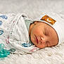 Elijah joined the competition — help win amazing prizes! baby, newborn, sleeping, swaddle, hat, pacifier, blanket, footprint_pattern, beanie, cozy, soft_texture, infant, face, eyes_closed, peaceful, portrait, skin, lying_down, white_background, newborn_photo