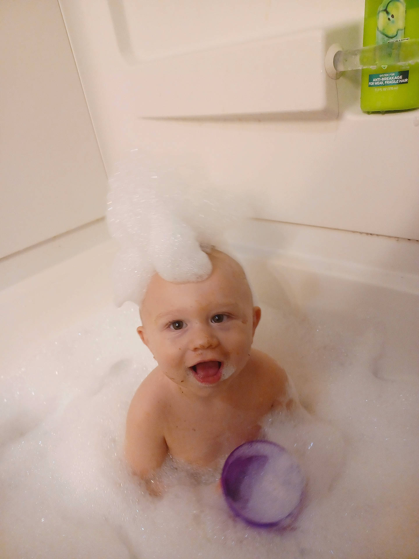 Tyler is registered to the contest to win money with this photo: baby, bathing, bathtub, bubble, face, foam, head, person, photography, portrait, soap, tub, washing
