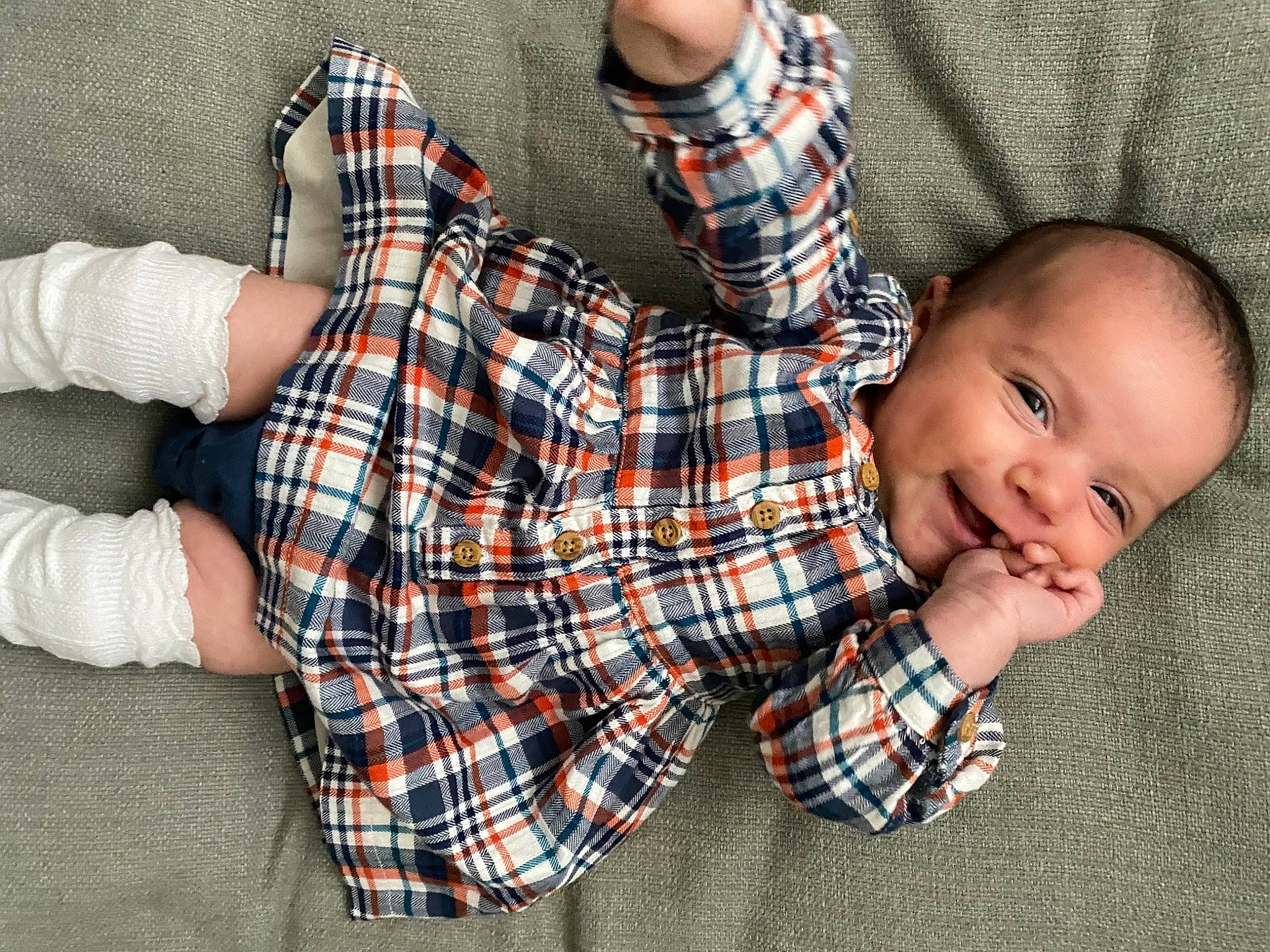 Atlas joined the competition — help win amazing prizes! baby, baby_toddler_clothing, comfort, finger, flooring, hand, happy, joy, leg, linens, orange, pattern, person, plaid, sleeve, smile, sock, tartan, textile, thigh