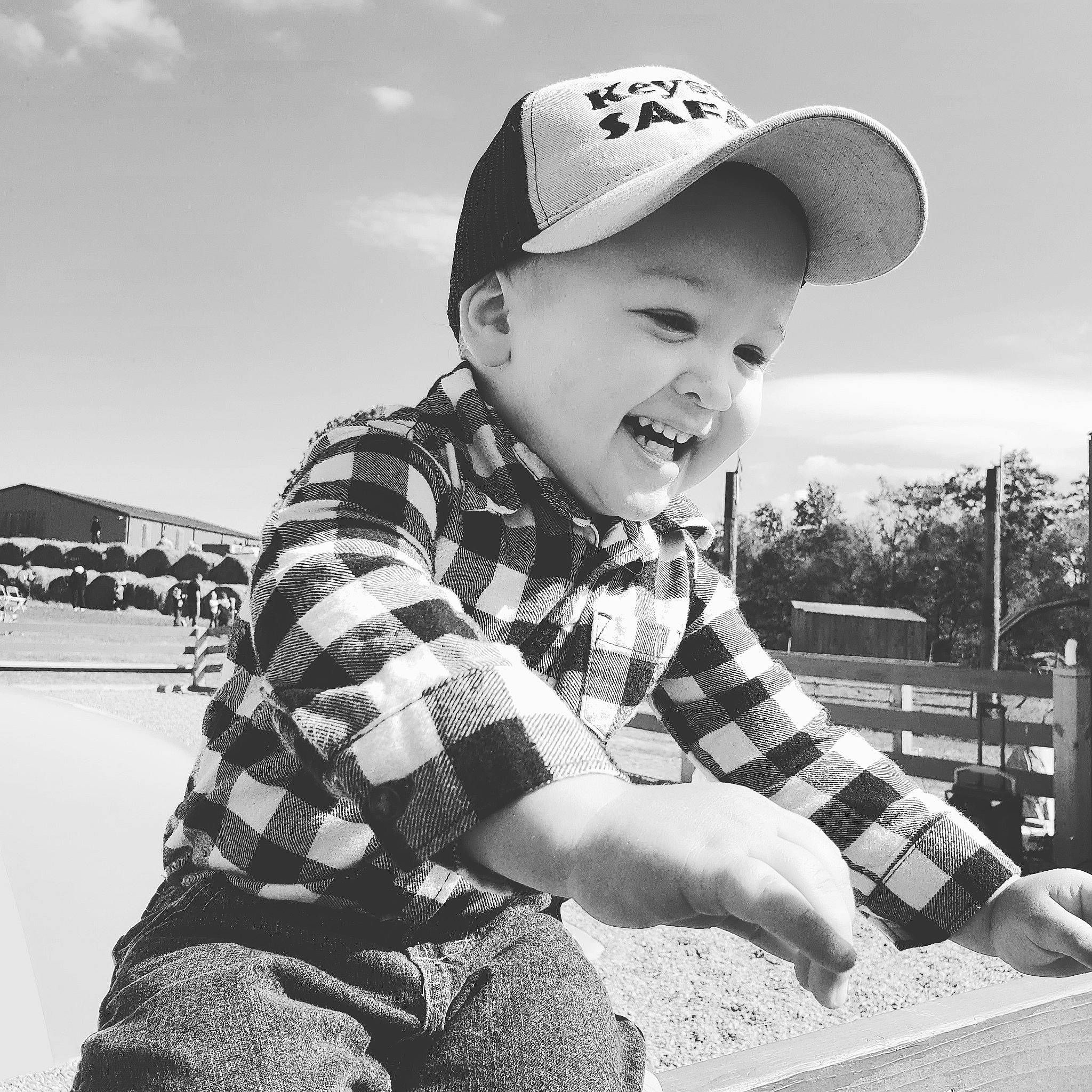 Grant is registered to the contest to win money with this photo: baby_toddler_clothing, baseball_cap, bonnet, cap, cool, cricket_cap, facial_expression, headwear, monochrome, pattern, person, plaid, tartan, trucker_hat