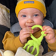 Aïko participe au concours pour gagner de l'argent avec cette photo : baby, child, teether, giraffe, hat, yellow, blanket, car_seat, smile, hands, blue_eyes, clothing, infant, cute, warm, cozy, soft, closeup, portrait, happy