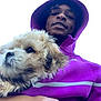 person, puppy, dog, hoodie, purple_hoodie, selfie, portrait, cute, holding, outdoors, sky, young_male, smile, pet, fur, closeup, hand, casual_clothing, hood, face