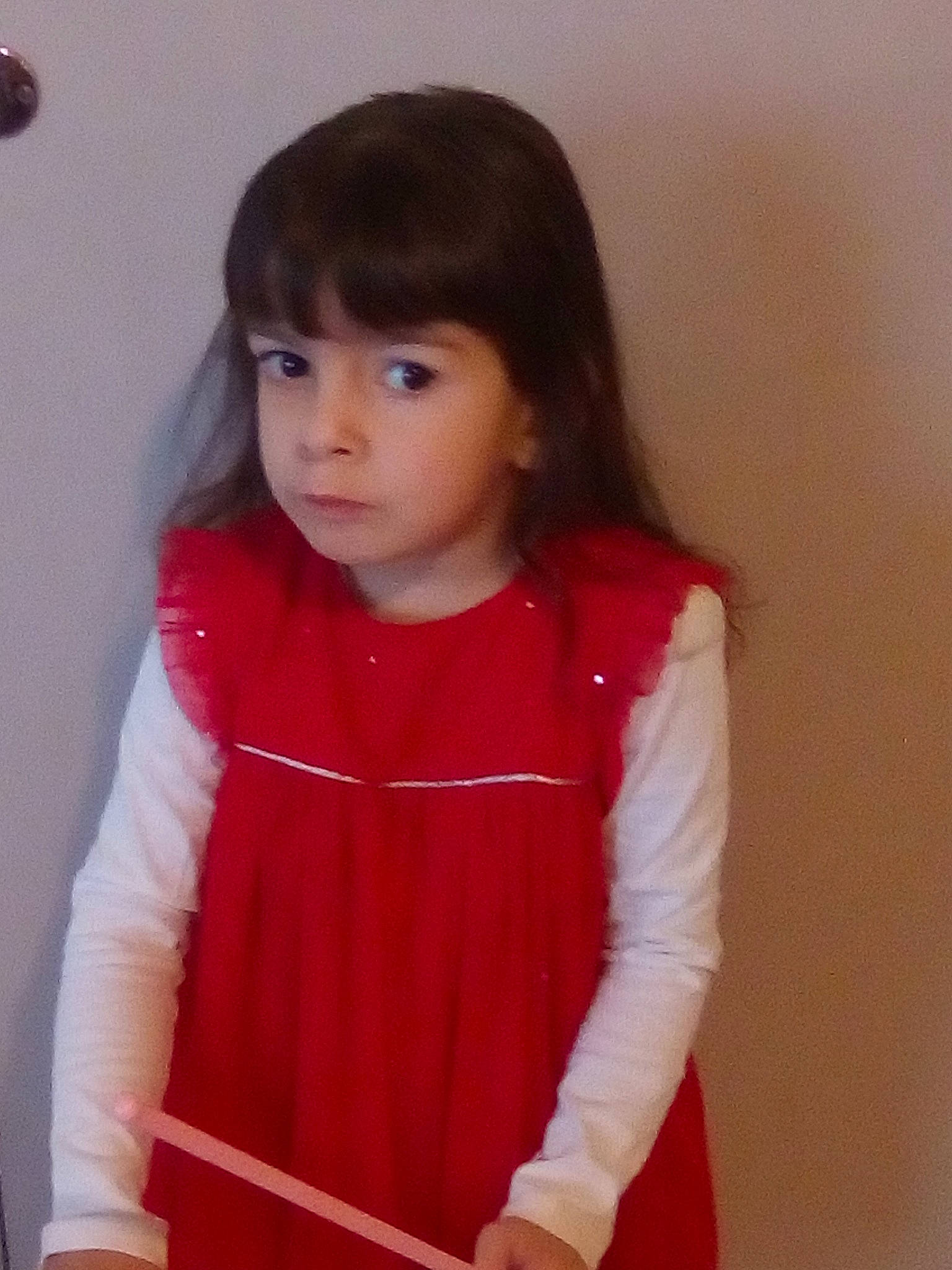 Victoire participe au concours pour gagner de l'argent avec cette photo : black_hair, brown_hair, cheek, child, child_model, forehead, girl, hair, hairstyle, human_hair_color, long_hair, outerwear, person, product, red, shoulder, skin, standing, textile, toddler