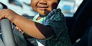 Elias joined the competition — help win amazing prizes! child, toddler, smiling, curly_hair, steering_wheel, car_interior, sunlight, portrait, happy, green_shirt, shorts, seat, window, daylight, closeup, baby, person, casual_clothing, indoor, cute