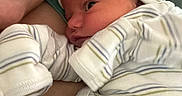 Jasper joined the competition — help win amazing prizes! newborn, baby, infant, adult, parent, cuddling, portrait, close_up, smiling, face, eyes, striped_clothing, swaddle, hat, hospital, pacifier, family, indoors, candid, cozy