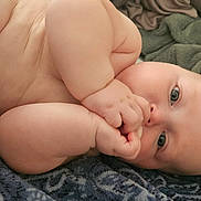 Abel is registered to the contest to win money with this photo: baby, blanket, blue_eyes, child, comfort, cozy, curious, cute, diaper, face, hand, indoors, infant, lying_down, pacifier, person, plush, skin, soft, toy_car