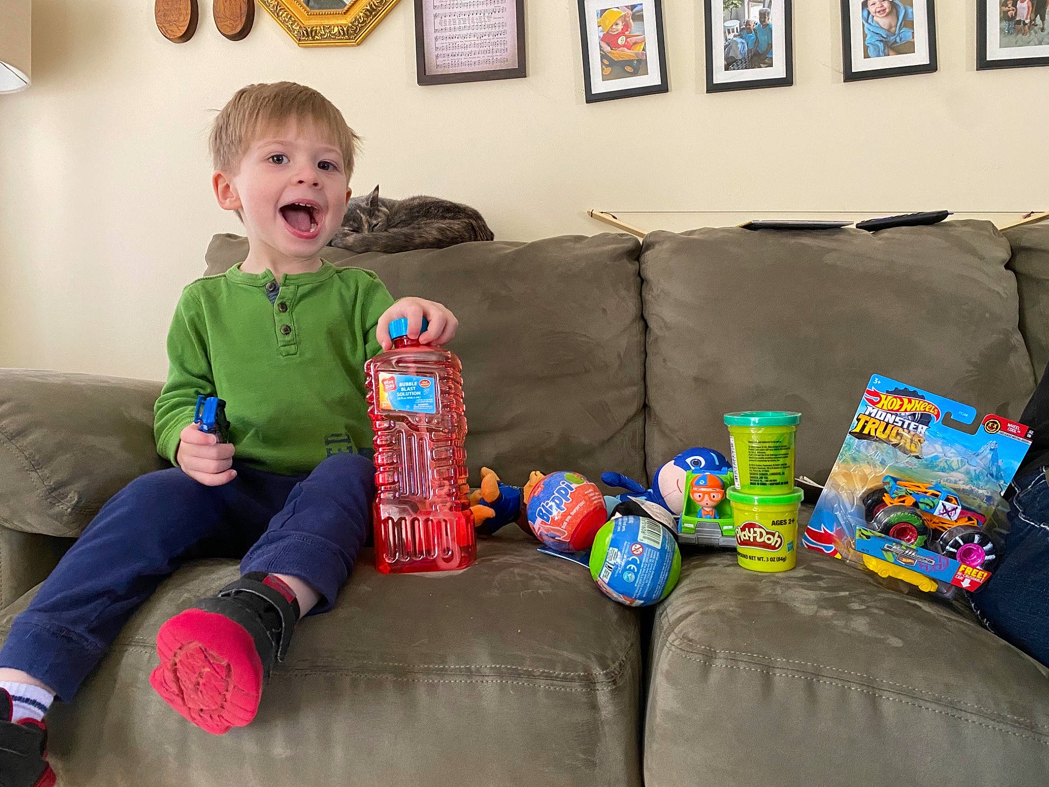 Maddux is registered to the contest to win money with this photo: baby, baby_toddler_clothing, blue, child, comfort, couch, event, flooring, fun, happy, leisure, living_room, person, picture_frame, play, room, sitting, smile, sofa_bed, toddler