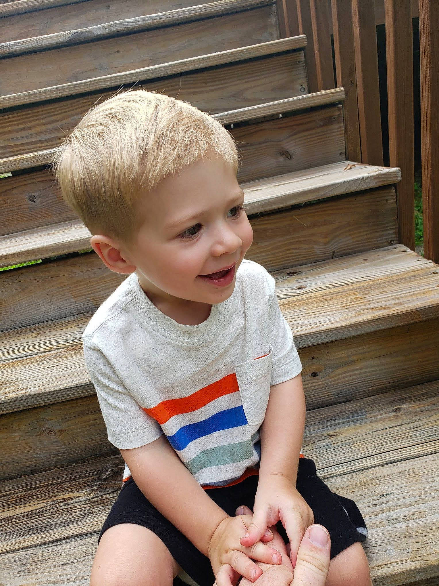 Maddux is registered to the contest to win money with this photo: baby_toddler_clothing, beauty, blond, cheek, child, chin, facial_expression, flooring, hairstyle, happy, human_leg, joy, knee, person, skin, sleeve, smile, standing, t_shirt, thigh