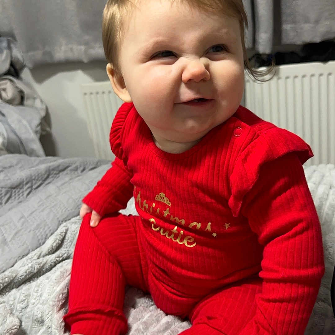 Arabella-Rois joined the competition — help win amazing prizes! baby, bed, bedroom, bodypart, clothing, face, finger, furniture, hand, happy, head, indoors, knitwear, pants, person, photography, portrait, room, sitting, sweater