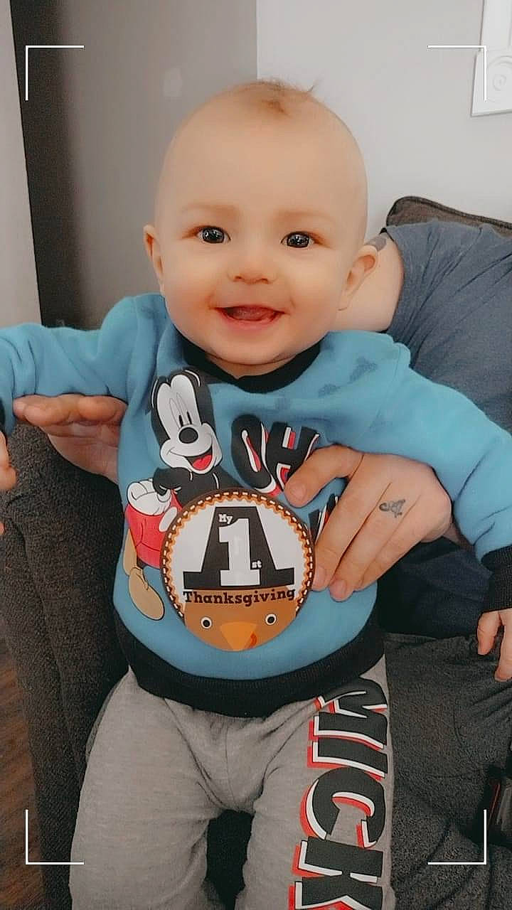 John Presley joined the competition — help win amazing prizes! baby, baby_products, baby_safety, baby_toddler_clothing, bib, cheek, child, electric_blue, fun, happy, joy, person, personal_protective_equipment, room, sitting, sleeve, smile, sportswear, t_shirt, thumb