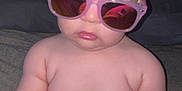 Nathaniel is registered to the contest to win money with this photo: accessory, baby, casual, child, chubby, cute, expressionless, furniture, glasses, hand, head, indoors, infant, person, plush_toy, portrait, seated, skin, sunglasses, toy