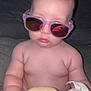 baby, sunglasses, plush_toy, child, cute, indoors, portrait, person, skin, head, hand, furniture, chubby, seated, toy, accessory, glasses, expressionless, infant, casual