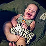 Nathaniel joined the competition — help win amazing prizes! baby, smiling, happy, plush_toy, zebra, stuffed_animal, child, cushion, indoor, portrait, cute, infant, clothing, sitting, feet, hand, face, joy, cozy, relax