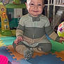 baby, ball, child, colorful, cute, face, floor, footwear, furniture, hand, happy, head, indoor, onesie, person, playmat, playroom, sitting, smile, toy