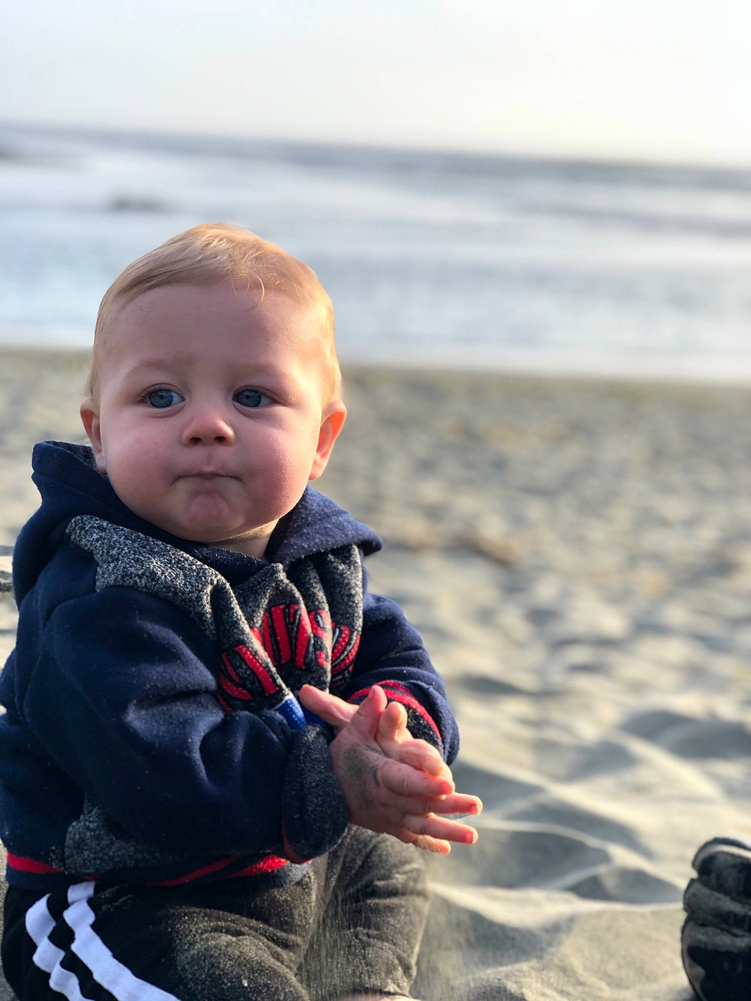 Dash is registered to the contest to win money with this photo: baby, beach, child, coast, fun, ocean, person, photography, play, sand, sea, skin, sky, smile, toddler, vacation, water, winter