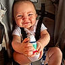 Riot joined the competition — help win amazing prizes! baby, child, stroller, socks, holding, cheeky, face, expression, clothing, seatbelt, indoor, cute, infant, person, funny_face, legs, hands, casual, smiling, closeup
