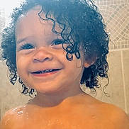 Jakarii joined the competition — help win amazing prizes! toddler, child, smiling, curly_hair, wet_hair, water_droplets, bathroom, tile_wall, portrait, close_up, happy, skin, face, head, young_child, person, cute, indoors, shower, expression