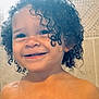 bathroom, child, close_up, curly_hair, cute, expression, face, happy, head, indoors, person, portrait, shower, skin, smiling, tile_wall, toddler, water_droplets, wet_hair, young_child