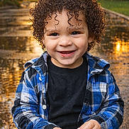 Jakarii is registered to the contest to win money with this photo: autumn_leaves, blue_shirt, child, curly_hair, cute, daylight, fall, happy, nature, outdoor, person, plaid_shirt, playing, portrait, rain, seasonal, smiling, sunset, toddler, wet_path