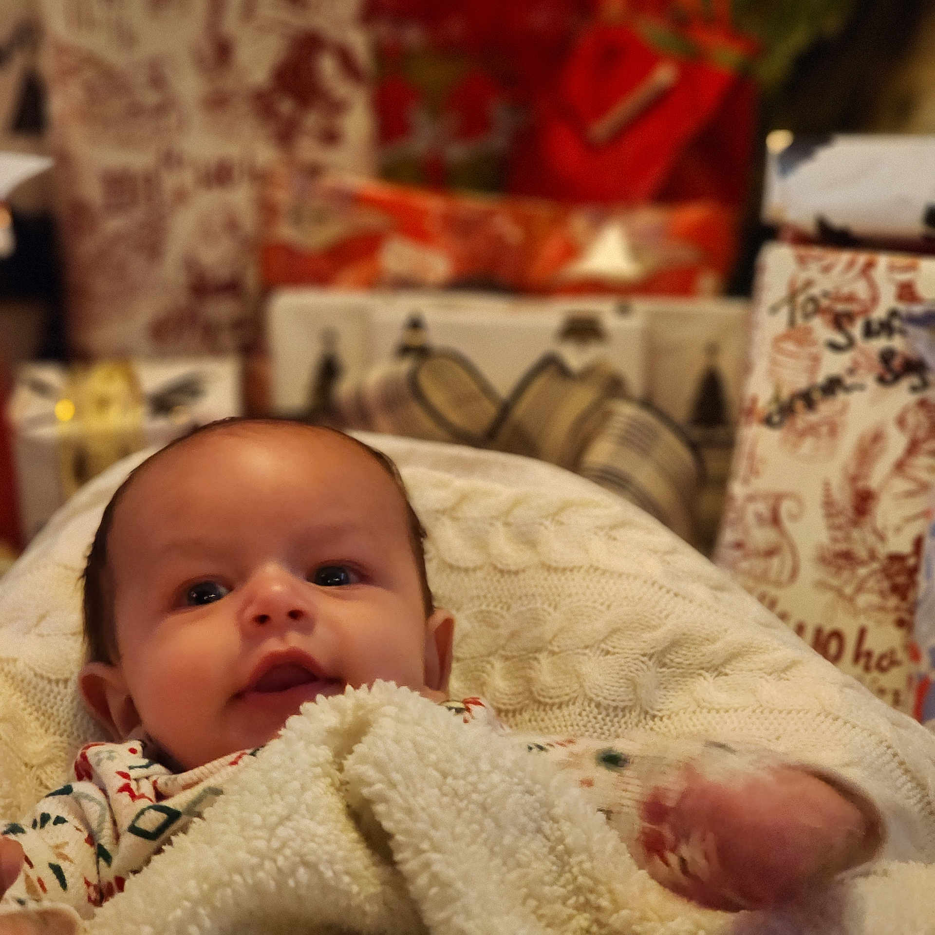 Ezekiel joined the competition — help win amazing prizes! baby, blanket, face, infant, child, holiday, gift, present, cozy, warm, cute, smile, indoors, knit, texture, childhood, wrapped, soft, festive, portrait