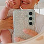 Kaïs a rejoint le concours — aidez-le/la à gagner de superbes lots ! baby, woman, selfie, mirror, smartphone, glitter_phone_case, smile, face, hand, indoor, portrait, holding, curious, closeup, skin, person, child, casual, happy, family