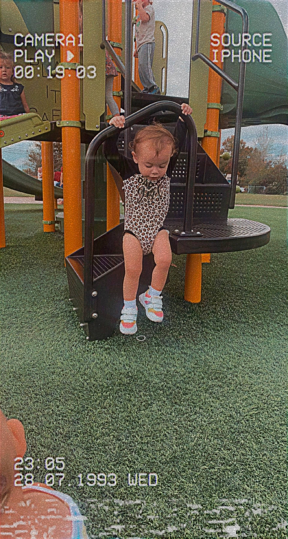 Zoey is registered to the contest to win money with this photo: baby_toddler_clothing, boot, city, flooring, fun, grass, human_leg, knee, leisure, outdoor_play_equipment, person, play, playground, recreation, shorts, sneakers, sock, sportswear, t_shirt, thigh