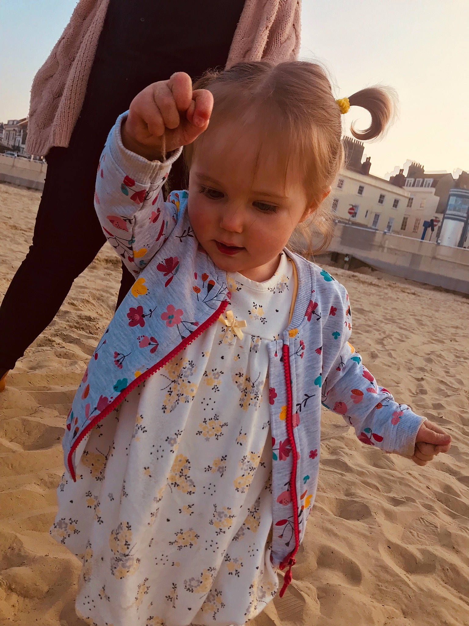 Caitlin is registered to the contest to win money with this photo: baby, child, fun, gesture, outerwear, person, play, sand, sleeve, smile, toddler, vacation
