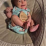 baby, infant, smiling, onesie, flower_pattern, baby_seat, cushion, wooden_sign, three_months, happy, face, feet, hand, skin, cute, child, indoors, soft_fabric, portrait, person