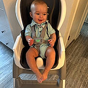 David joined the competition — help win amazing prizes! baby, high_chair, bow_tie, smile, indoor, child, floor, furniture, seat_belt, clothing, happy, person, face, legs, hands, wood_floor, doorway, wall, modern, cute