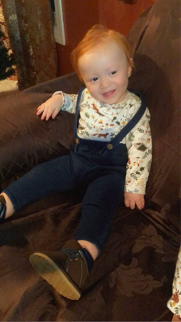 Jadiel is registered to the contest to win money with this photo: baby, baby_toddler_clothing, cheek, comfort, face, floor, flooring, fun, hairstyle, head, joy, knee, lap, leg, person, sleeve, smile, standing, textile, thigh