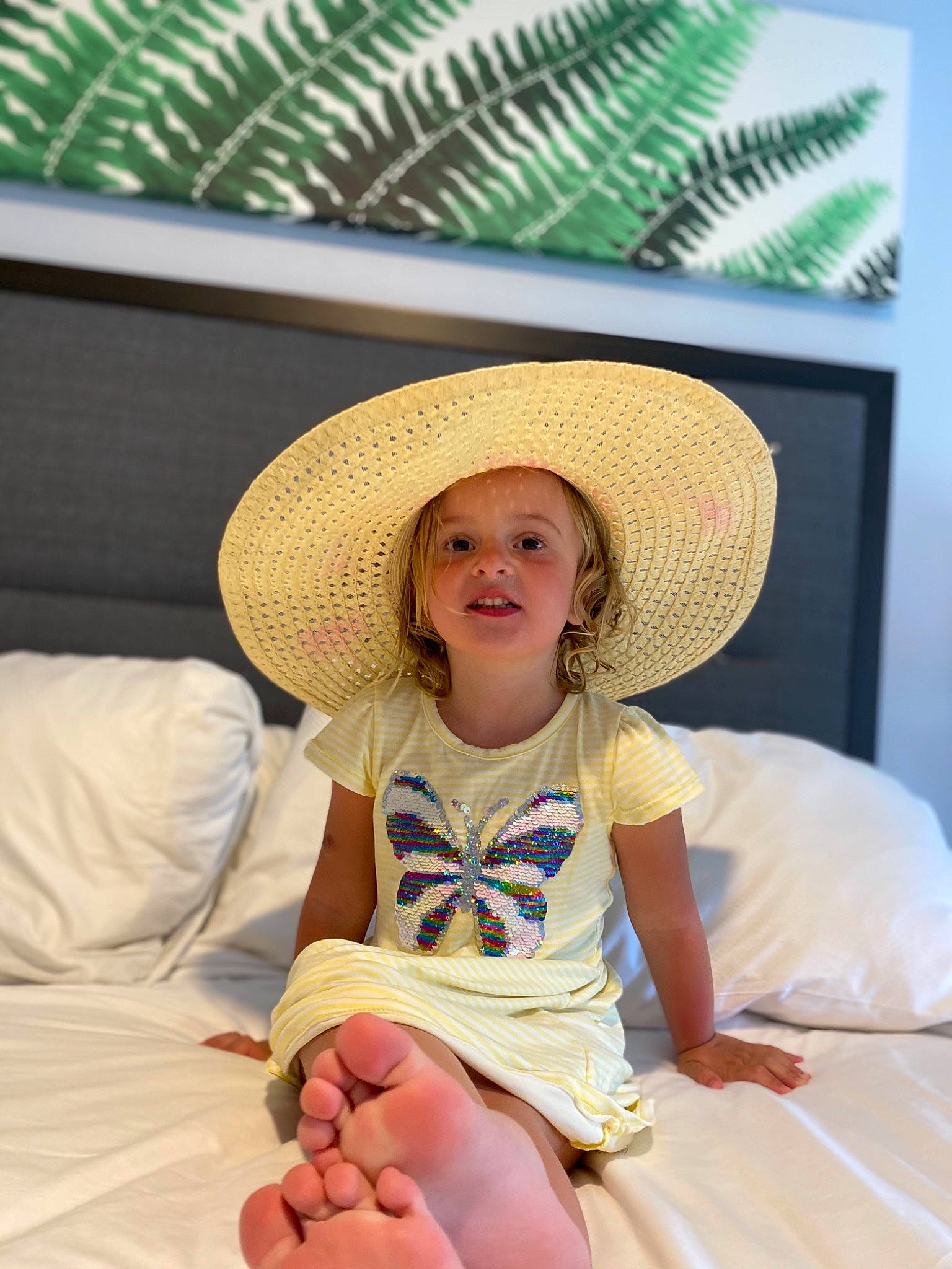 Amina is registered to the contest to win money with this photo: arecales, baby_toddler_clothing, comfort, cowboy_hat, dress, eye, fun, happy, hat, head, headgear, human_body, human_leg, knee, person, skin, smile, sun_hat, thigh, toddler