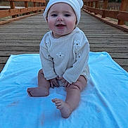 Zaylee is registered to the contest to win money with this photo: baby, infant, child, knit_hat, sweater, blanket, wooden_bridge, boardwalk, outdoor, trees, smile, sitting, bare_feet, cute, portrait, cozy, fall, depth_of_field, railing, happy