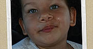 Khloe is registered to the contest to win money with this photo: child, toddler, face, pigtails, white_shirt, car_interior, portrait, smile, ribbon, award, green, hair, cute, young, person, seat, window, daylight, expression, casual